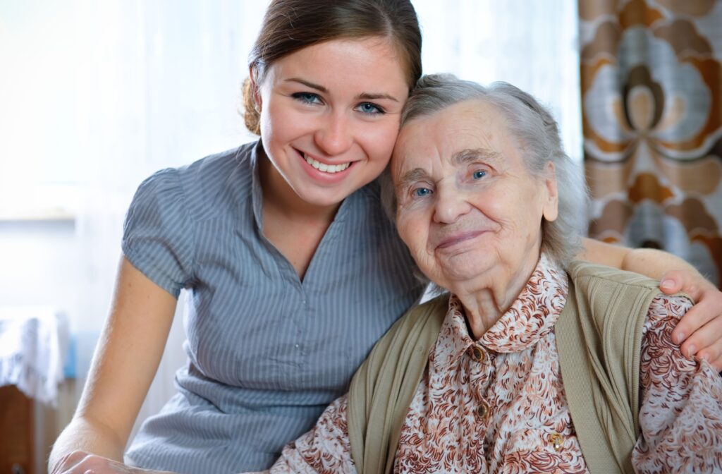 An adult child hugs their older parent after a move to senior living.