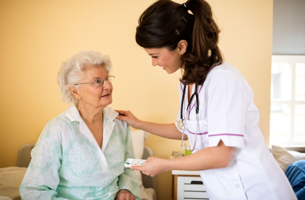 Someone has their morning medication and checkup from a nurse at a skilled nursing facility.